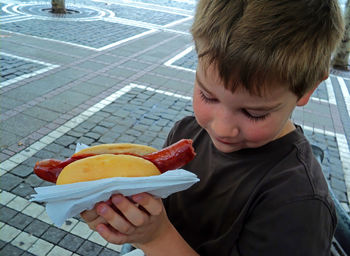 Close-up of boy holding hotdog