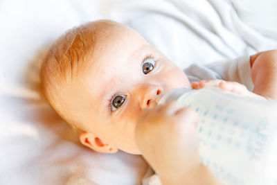 Portrait of cute baby boy sleeping on bed at home