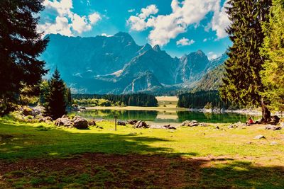 Scenic view of lake and mountains against sky