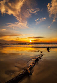 Scenic view of beach against sky during sunset