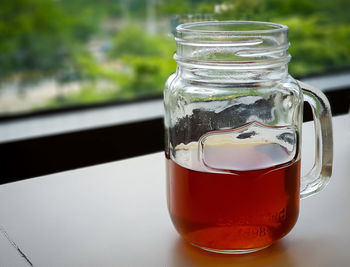 Close-up of drink in glass jar on table