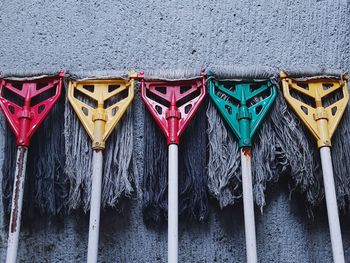 Close-up of multi colored umbrellas hanging against wall