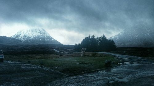 Scenic view of landscape against cloudy sky