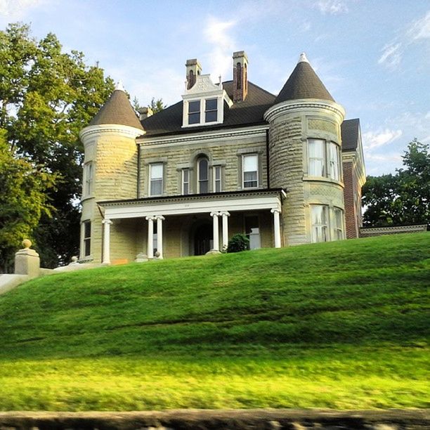 architecture, grass, built structure, building exterior, lawn, sky, tree, green color, history, facade, travel destinations, famous place, arch, grassy, day, outdoors, architectural column, park - man made space, travel, incidental people