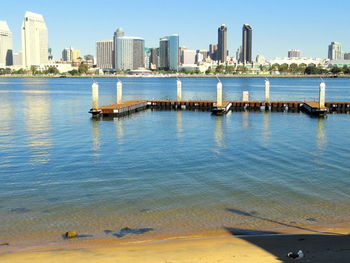 Pier over sea against buildings in city