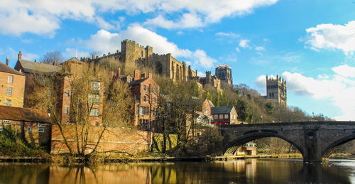 Bridge over river with buildings in background