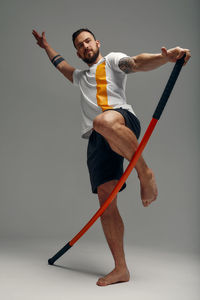 Low angle view of boy playing with arms raised