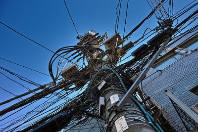 Low angle view of telephone line against sky