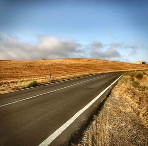 Road on field against sky