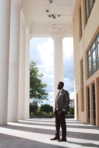 Full length of businessman standing outside building