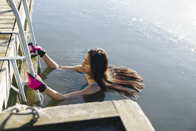 Woman swimming in cold lake