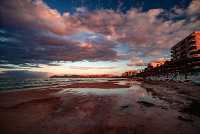 Scenic view of beach against sky during sunset