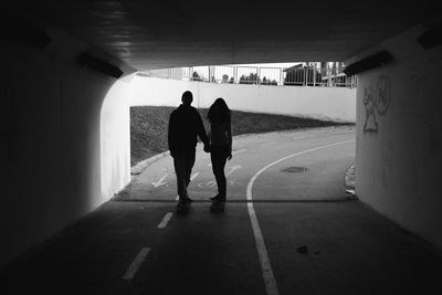 Rear view of silhouette people walking in corridor