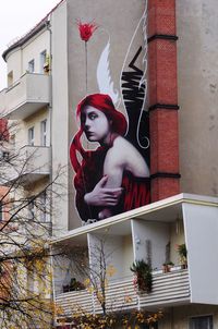 Mid adult woman against built structure