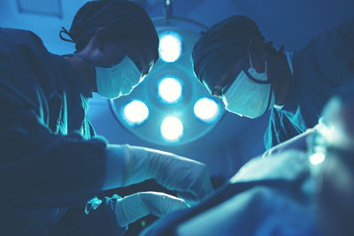 In a operating room, a doctor or medical team is performing a surgical procedure. person