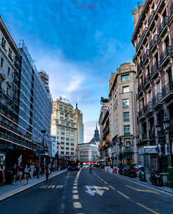 City street amidst buildings against sky