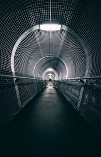 Empty illuminated covered footbridge