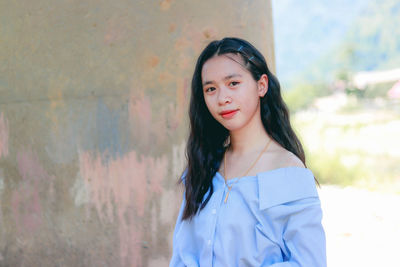 Portrait of a beautiful young woman standing outdoors