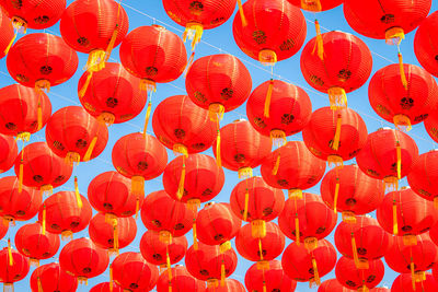 Low angle view of lantern hanging in orange