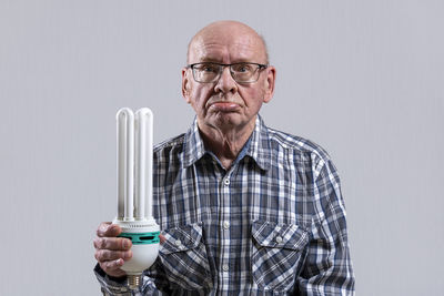 Portrait of man wearing mask against white background