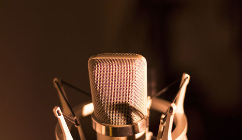 Close-up of microphone against black background