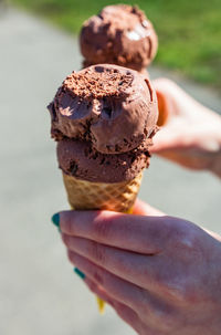 Cropped hand of person holding ice cream cone