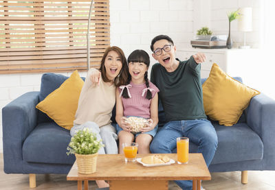 Portrait of friends sitting on sofa