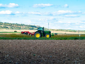 Tractor on field against sky