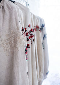 Close-up of clothes hanging on bed