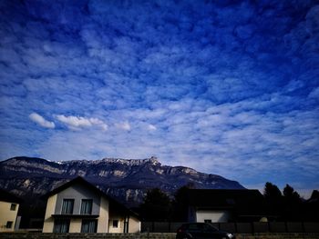 Houses against cloudy sky