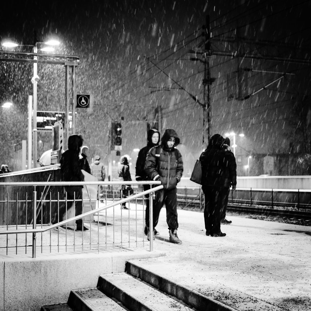 men, lifestyles, night, full length, leisure activity, rear view, illuminated, person, togetherness, walking, standing, medium group of people, casual clothing, railing, city, city life, street