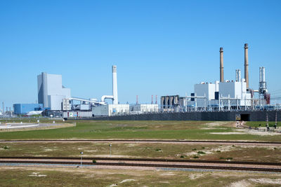 View of factory against blue sky