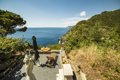 Scenic view of deck chair against clear sky