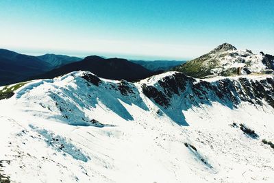 Scenic view of mountains against clear blue sky