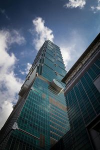 Low angle view of building against cloudy sky