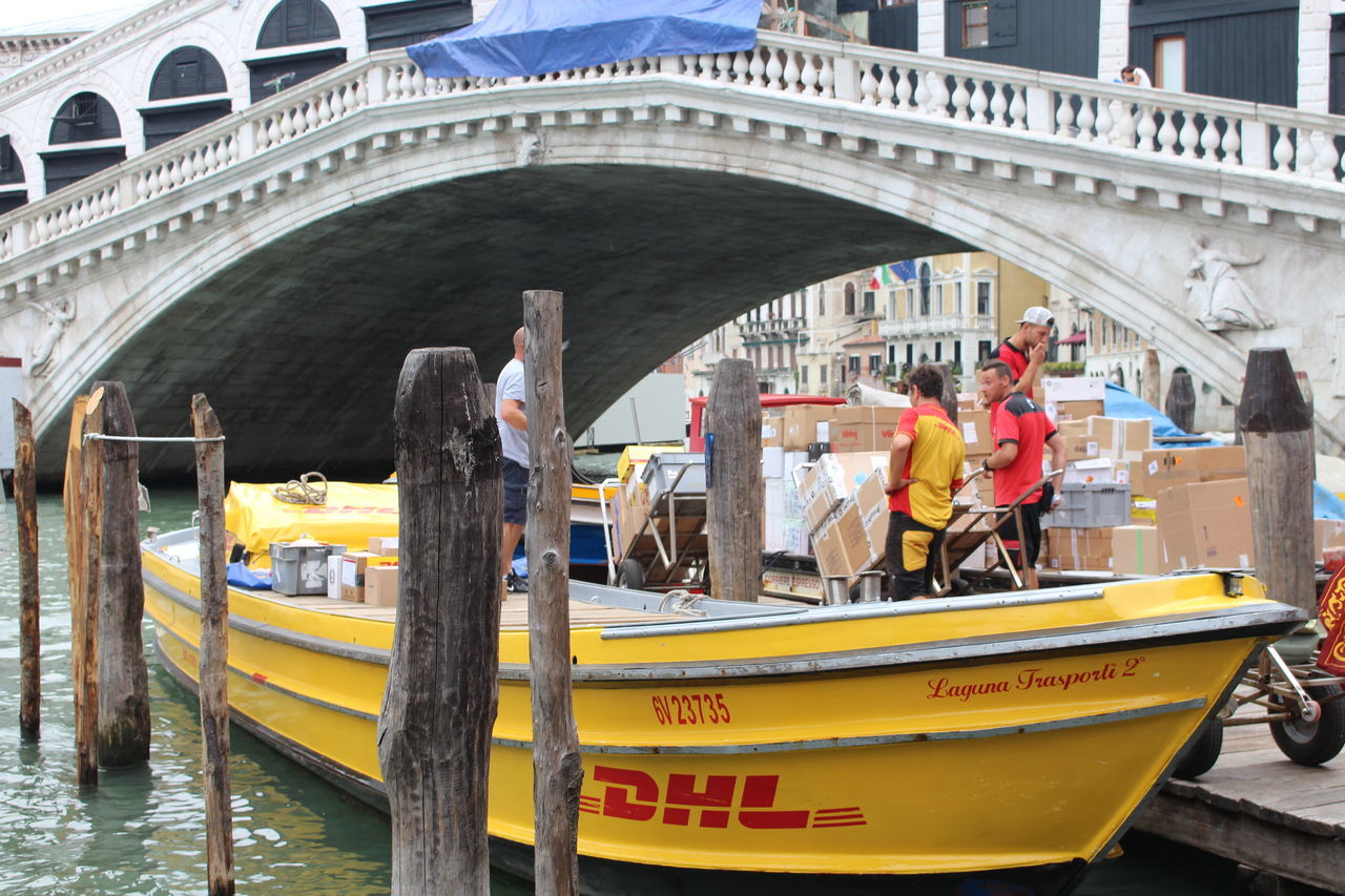 nautical vessel, transportation, water, boat, mode of transport, architecture, built structure, connection, river, gondola - traditional boat, bridge - man made structure, arch, travel destinations, engineering, day, outdoors, waterfront, journey, bridge, famous place, passenger craft