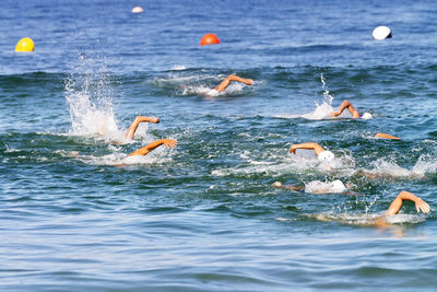 People swimming in sea