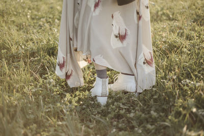 Low section of people standing on field