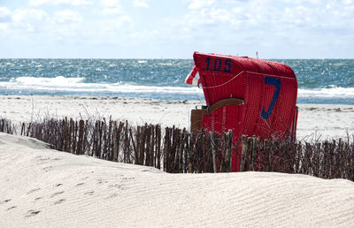 Lifeguard hut on beach against sky