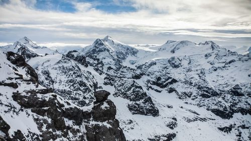 Scenic view of snow covered mountains against sky