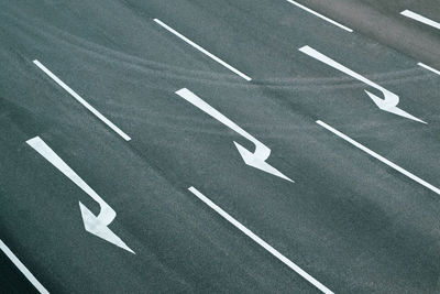 High angle view of arrow symbol on road