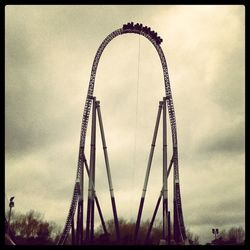 Low angle view of ferris wheel against sky