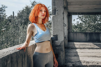 Fitness woman sitting on floor. woman taking rest after working out 