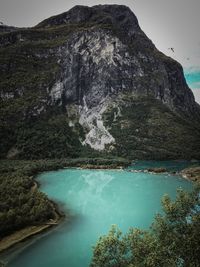 Scenic view of lake and mountains against sky