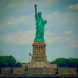 Low angle view of statue against cloudy sky