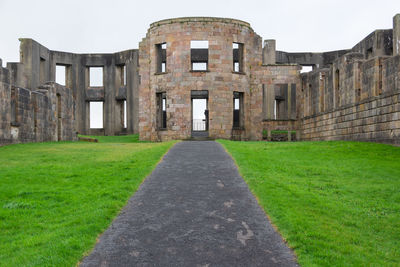 Old ruin amidst field against clear sky