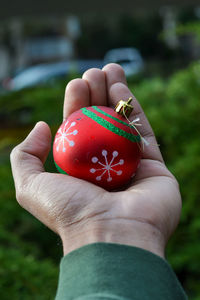 Close-up of hand holding strawberry