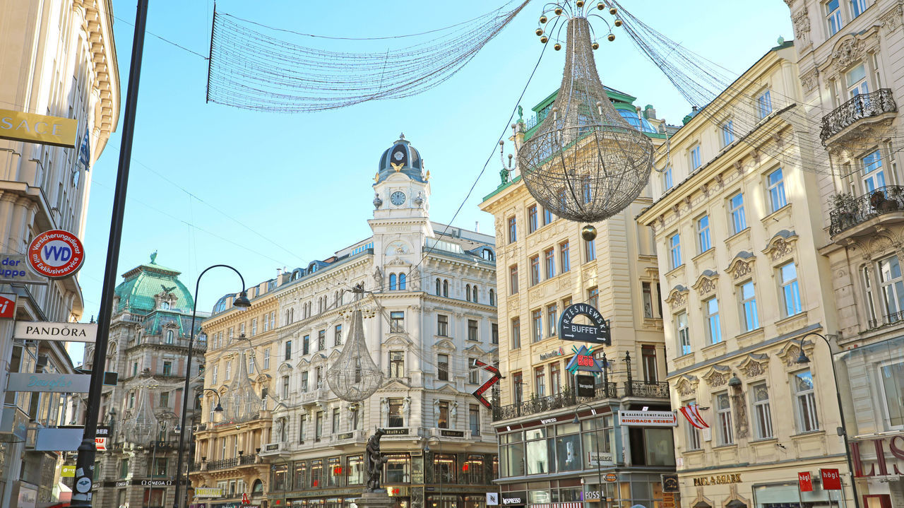 LOW ANGLE VIEW OF BUILDINGS IN CITY AGAINST SKY