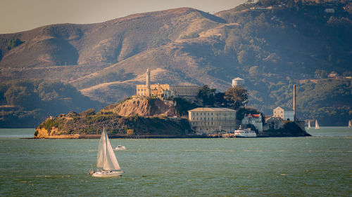 Scenic view of sea and mountains against sky