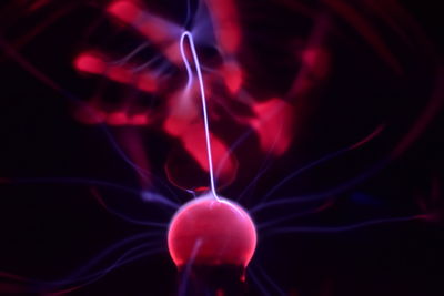 Close-up of lit candle against black background